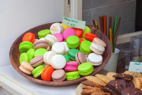Macaroons on display in a bakery window Stock Photos