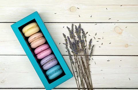 Macaroons in gift box next to lavender Stock Photos