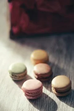 Macaroons illuminated by sun rays casting their shadow Stock Photos