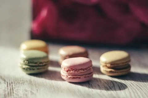 Macaroons illuminated by sun rays casting their shadow Stock Photos