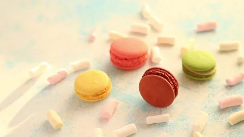 Macaroons with marshmallows on a blue background Stock Footage 168009409