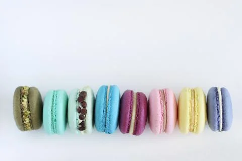 Macaroons multicolored in a row with place for text. Sweet food, not healthy foo Stock Photos