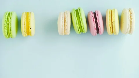 Macaroons or macaron on pastel blue surface. Close up. Video stock 116016255