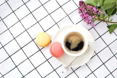 Macaroons on plate on a checkered tablecloth Stock Photos