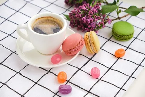 Macaroons on plate on a checkered tablecloth Stock Photos
