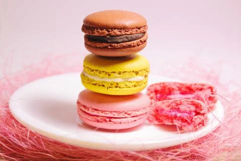 Macaroons stack of different colors standing on white plate. Front view. Stock Photos