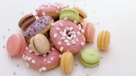 Macaroons, sweets are spinning. Many multi-colored macaroons donuts with Stock Footage 194840472
