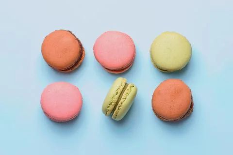 Macaroons in three different colors on blue background Stock Photos