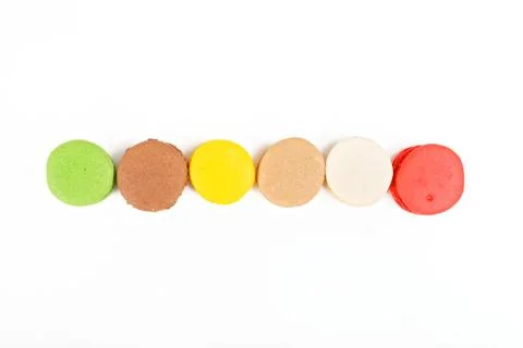 Macaroons on a white background. A row of colored macaroons. View from above. Stock Photos