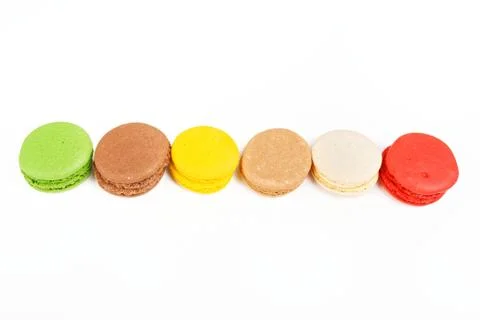 Macaroons on a white background. A row of colored macaroons. Stock Photos