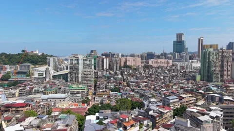 Macau cityscape flight over old town rooftops toward Guia Fortress and Lighthous Stock Footage 340199538
