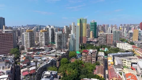 Macau dense residential skyline flight over crowded rooftops and hillside towers Stock Footage 340199704