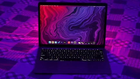 A MacBook air laptop's with vibrant display zoomed out moving shot Stock Footage 152577947