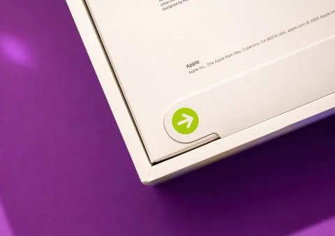 MacBook Air M4 Box Pull Tab on Purple Surface Stock Photos