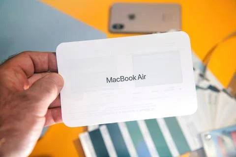 MacBook Air Quick Start Guide Held in Hand Stock Photos