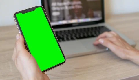 Macbook and mobile phone with green screen Stock Photos