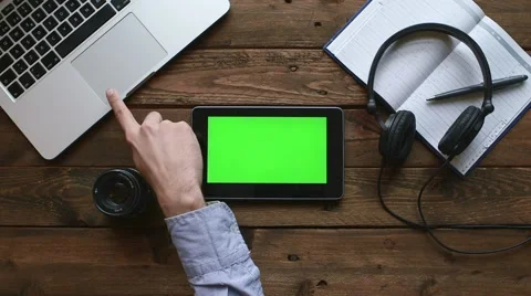 Macbook pro on dark oak desk with android tablet Stock Footage 63539323