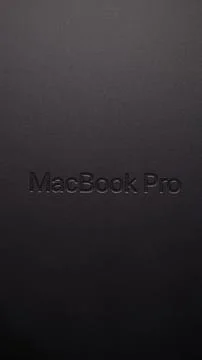 MacBook Pro logo engraved on Space Black metallic surface Stock Photos