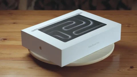 MacBook Pro packaging on a wooden table Stock Footage 322025143