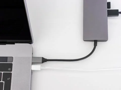 Macbook pro, with usb-c hub on white desk Stock Photos