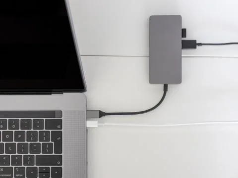 Macbook pro, with usb-c hub on white desk Stock Photos