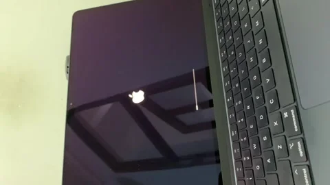MacBook screen displaying a system update progress bar during the macOS update Stock Footage 312026959