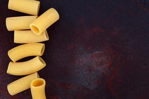 Maccheroni raw pasta on rusty background Stock Photos