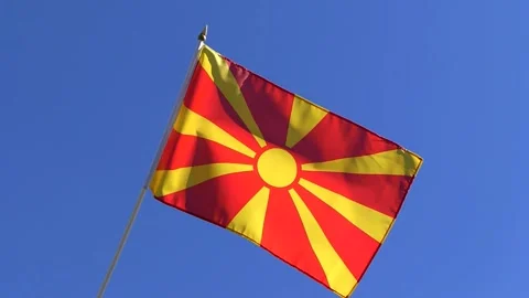 The Macedonian flag waving in the wind in the blue sky Stock Footage 282432838