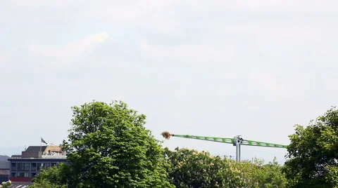 Mach 5 fairground thrill ride stretching 55 metres high over trees in Bolton Stock Footage 67997486