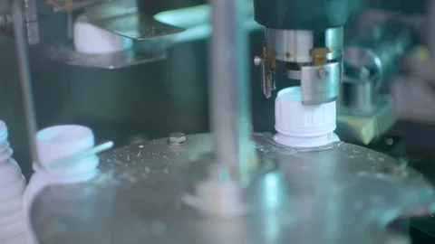 The machine is adding liquid to the bottles in industrial plants. Stock Footage 128344469