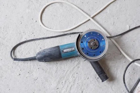 The machine for angle grinding lies after working with building materials on  Stock Photos