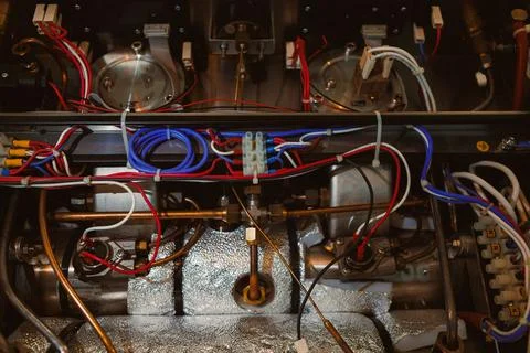 A machine assembly shows a network of wires and components with various conne Stock Photos