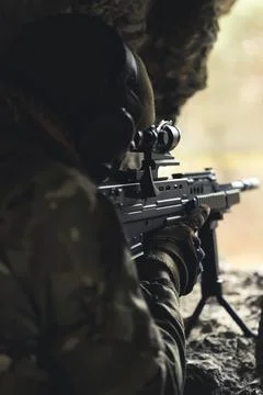 Machine automatic rifle precise aim from a rat hole in a destructed building Stock Photos