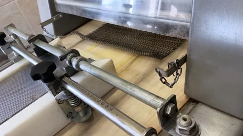 Machine at the bakery, kneading the dough and eject it on the production line Stock Footage 252116257