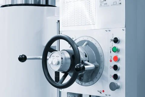 A machine with a black and silver handle with a white and black knob. The kno Stock Photos