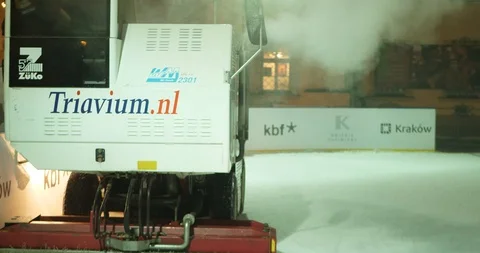 Machine Cleans Ice Skating Rink at Night. 4K Stock Footage 86311599