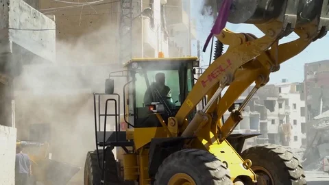 Machine clears rubble from streets of Raqqah, Syria Stock Footage 94565334