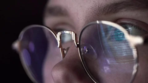The Machine Code is Reflected in the Hacker's Glasses. Close-up Shot Stock-Footage 70817493