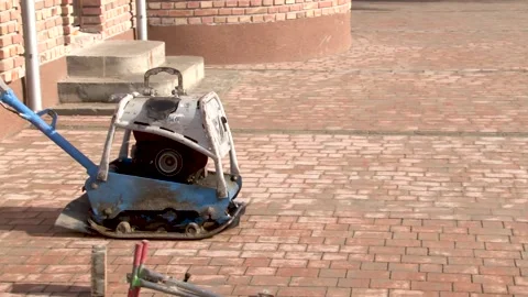 Machine for compaction, vibrating plates on paving stones. Stock Footage 234132778