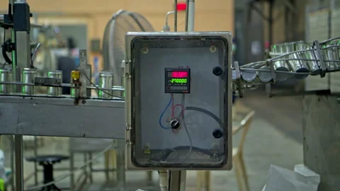 A machine for counting the number of cans flowing into the process Stock Footage 339009283