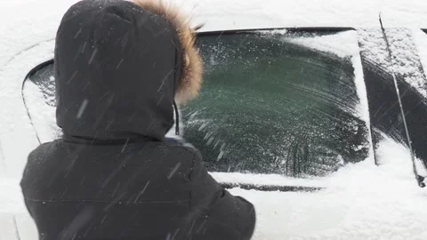 Machine, covered with snow. A man brushing snow from the car. Stock Footage 146111410