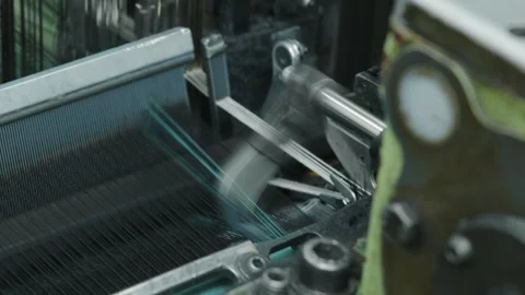 Machine creating fabric and textile with blue thread in a factory Stock Footage 291870569