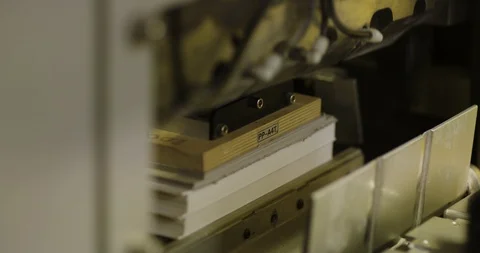 The machine cuts off excess paper in books. Stock-Footage 113629217