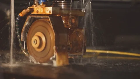 The machine cuts the glass according to the program and is cooled by water Stock Footage 105367633