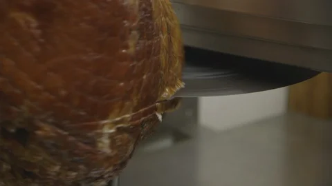 Machine cuts honey baked ham Stock Footage 104872709