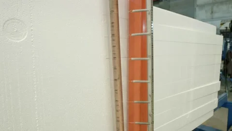 The machine that cuts the styrofoam block of the machine in the factory. Stock Footage 169493319