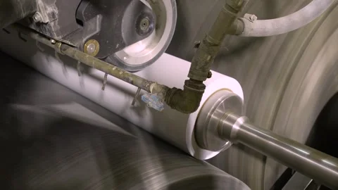 A machine for cutting rolls of white paper. Paper production Stockbeeldmateriaal 301498131