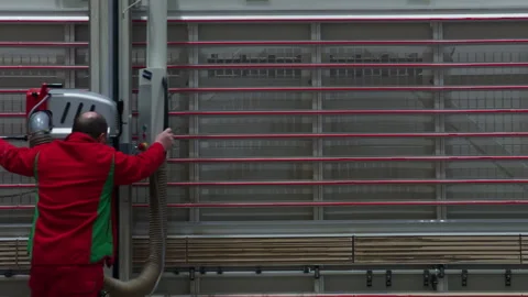 A machine is cutting wood in large department store with a hose attached to it Stock Footage 270054970