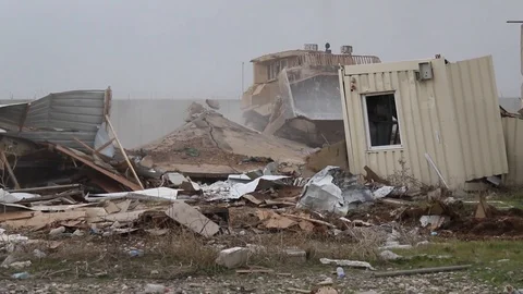 Machine destroying metal containers and houses. Stock Footage 104715069