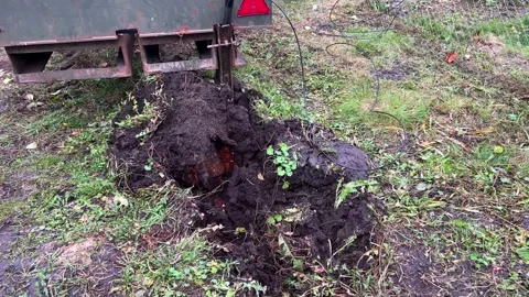 Machine digging trench in dirt and grass for groundwork and cable installation Stock Footage 337062511